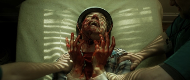 BASEMENT 2- Chester writhes in agony after his attack on Sophie - image from film